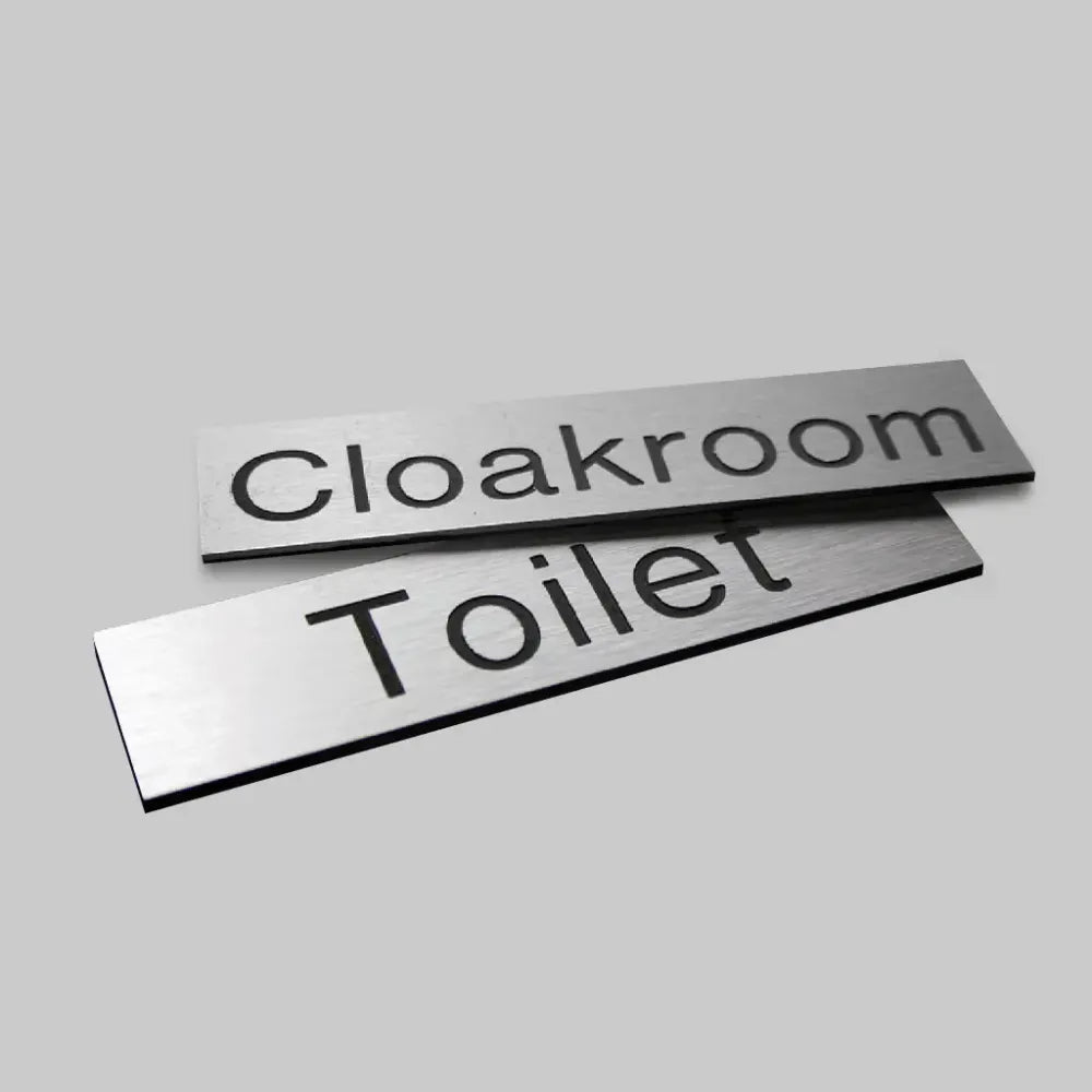 Engraved Sign with adhesive backing - 140x35mm dia Black text on aluminium effect