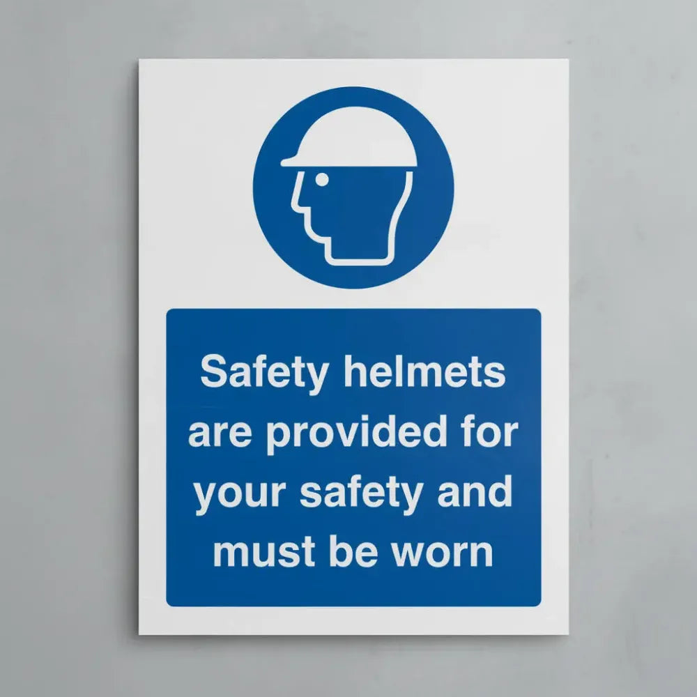 15540E Safety helmets are provided for your safety and must be worn (semi rigid pvc safety sign) Rigid Plastic (200x150mm) Safety Sign