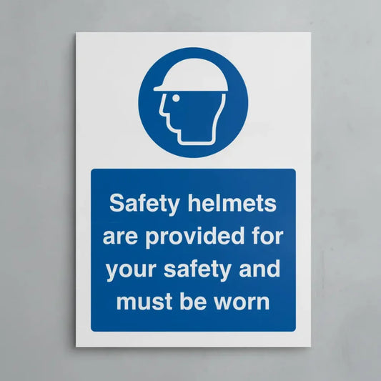 25540K Safety helmets are provided for your safety and must be worn (self adhesive vinyl safety label) Self Adhesive Vinyl (400x300mm) Safety Sign